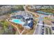 Aerial view of community center with pool, tennis courts, parking, and manicured landscaping at 4941 Adler Ct, Hoschton, GA 30548
