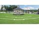 Community outdoor amphitheater and gathering space with a small stage and grassy seating at 4941 Adler Ct, Hoschton, GA 30548
