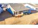 Aerial shot of a home's backyard with a covered patio and minimal plantings on a sunny day at 4941 Adler Ct, Hoschton, GA 30548