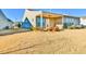 A well-maintained backyard featuring a covered patio, lawn, and minimal landscaping elements at 4941 Adler Ct, Hoschton, GA 30548