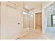 Bathroom featuring a glass-enclosed shower and an adjacent walk-in closet at 4941 Adler Ct, Hoschton, GA 30548