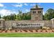 Stone entrance sign for the Del Webb Chateau Elan community with a stately stone tower at 4941 Adler Ct, Hoschton, GA 30548