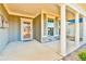 Inviting covered porch with stately columns, decorative trim, and stone accents on the home's facade at 4941 Adler Ct, Hoschton, GA 30548