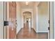 Inviting foyer with hardwood floors leads to an open floor plan with a fireplace visible in the background at 4941 Adler Ct, Hoschton, GA 30548