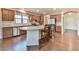Spacious kitchen features an island with bar seating, stainless steel appliances, and ample counter space at 4941 Adler Ct, Hoschton, GA 30548