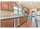 Modern kitchen featuring granite countertops and wood cabinetry at 4941 Adler Ct, Hoschton, GA 30548