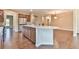 Spacious kitchen with stainless steel appliances, granite countertops, and hardwood floors at 4941 Adler Ct, Hoschton, GA 30548
