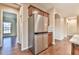 Kitchen area with stainless steel refrigerator and hardwood floors at 4941 Adler Ct, Hoschton, GA 30548