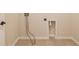 Laundry room with hookups for a washer and dryer and neutral paint at 4941 Adler Ct, Hoschton, GA 30548