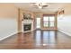 Bright living room featuring hardwood floors, fireplace, and plenty of natural light at 4941 Adler Ct, Hoschton, GA 30548