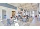 Expansive lounge area featuring high ceilings, chandeliers, and comfortable seating, perfect for socializing at 4941 Adler Ct, Hoschton, GA 30548