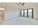 Large main bedroom with carpeting, ceiling fan, and ample natural light at 4941 Adler Ct, Hoschton, GA 30548