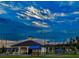 Outdoor recreation area with bocce ball court, pavilion, benches and parking under a dramatic blue sky at dusk at 4941 Adler Ct, Hoschton, GA 30548