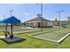 Outdoor recreation area with bocce ball court, pavilion, benches and parking under a clear blue sky at 4941 Adler Ct, Hoschton, GA 30548