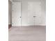 Spacious bedroom with neutral carpet and double doors at 507 Pearl St, Cumming, GA 30040