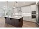 Modern kitchen with white cabinets, large island, and stainless steel appliances at 507 Pearl St, Cumming, GA 30040