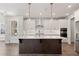 Modern kitchen with white cabinets, large island, and stainless steel appliances at 507 Pearl St, Cumming, GA 30040