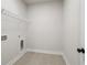 Laundry room with built-in shelving and tile floor at 507 Pearl St, Cumming, GA 30040