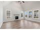 Spacious living room with hardwood floors, a fireplace, and large windows at 507 Pearl St, Cumming, GA 30040