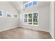 Sunlit home office with hardwood floors and multiple windows at 507 Pearl St, Cumming, GA 30040