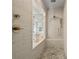 Spa-like shower with pebble floor and frameless glass door at 507 Pearl St, Cumming, GA 30040
