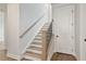 Modern staircase with wood treads and black railing at 507 Pearl St, Cumming, GA 30040