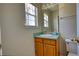 Simple bathroom with wood vanity, single sink, and window at 5908 Trent Walk Dr, Lithonia, GA 30038