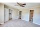 Spacious bedroom with ceiling fan, carpet flooring, and double closets at 5908 Trent Walk Dr, Lithonia, GA 30038