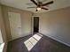 Bright bedroom featuring carpet, ceiling fan and ample closet space at 1334 To Lani Farm Rd, Stone Mountain, GA 30083
