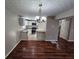 Open concept dining area with dark laminate floors and kitchen view at 1334 To Lani Farm Rd, Stone Mountain, GA 30083