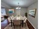 Bright dining room with hardwood floors and a large table, perfect for Gathering gatherings at 1334 To Lani Farm Rd, Stone Mountain, GA 30083