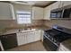 Kitchen with granite countertops, stainless steel appliances, and white cabinets at 1334 To Lani Farm Rd, Stone Mountain, GA 30083