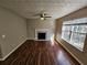 Spacious living room featuring a fireplace and large windows, offering ample natural light at 1334 To Lani Farm Rd, Stone Mountain, GA 30083