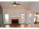 Living room with fireplace, hardwood floors, and large windows at 2335 Corbett Ct, Powder Springs, GA 30127