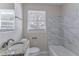 Updated bathroom with granite vanity and marble tile at 3426 Glensford Dr, Decatur, GA 30032