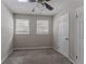 Simple bedroom with neutral walls, carpet, and two windows at 3426 Glensford Dr, Decatur, GA 30032