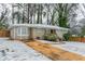 Brick ranch house with a snow covered yard and driveway at 3426 Glensford Dr, Decatur, GA 30032
