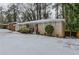 Ranch style home with red front door and snow covered lawn at 3426 Glensford Dr, Decatur, GA 30032