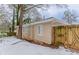 Back of house with wooden fence, snow on the ground at 3426 Glensford Dr, Decatur, GA 30032