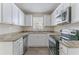 Updated kitchen with white cabinets and granite countertops at 3426 Glensford Dr, Decatur, GA 30032