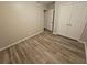 Bedroom with double closets and wood-look flooring at 385 Shannon Way, Lawrenceville, GA 30044