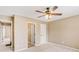 Neutral-toned bedroom with ceiling fan and multiple doors at 9706 Spyglass Dr, Villa Rica, GA 30180