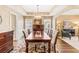 Bright dining room features a spacious table, hardwood floors, and elegant lighting at 9706 Spyglass Dr, Villa Rica, GA 30180