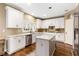 Modern kitchen with white cabinets, marble countertops, and hardwood floors at 9706 Spyglass Dr, Villa Rica, GA 30180