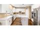 Modern kitchen with white cabinets, marble countertops, and hardwood floors at 9706 Spyglass Dr, Villa Rica, GA 30180