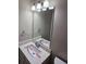 Bathroom features a vanity with a sink and mirror at 10577 Marigold Ct, Hampton, GA 30228