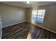 Spacious bedroom with wood-look floors and large window at 10577 Marigold Ct, Hampton, GA 30228