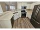 Modern kitchen with white cabinets, stainless steel appliances, and an island at 10577 Marigold Ct, Hampton, GA 30228