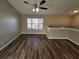 Bright living room with large window and wood-look flooring at 10577 Marigold Ct, Hampton, GA 30228