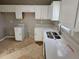 White kitchen features updated countertops and flooring at 2718 High Tide Dr, South Fulton, GA 30349